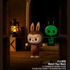A brown rabbit collectible figure blind box displayed in a dark, ornate setting.