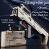 Khaki folding water gun shown in both expanded and folded sizes on a dark surface.