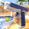 A hand holds a blue and white high-pressure water blaster toy gun, ready to fire in an outdoor setting.