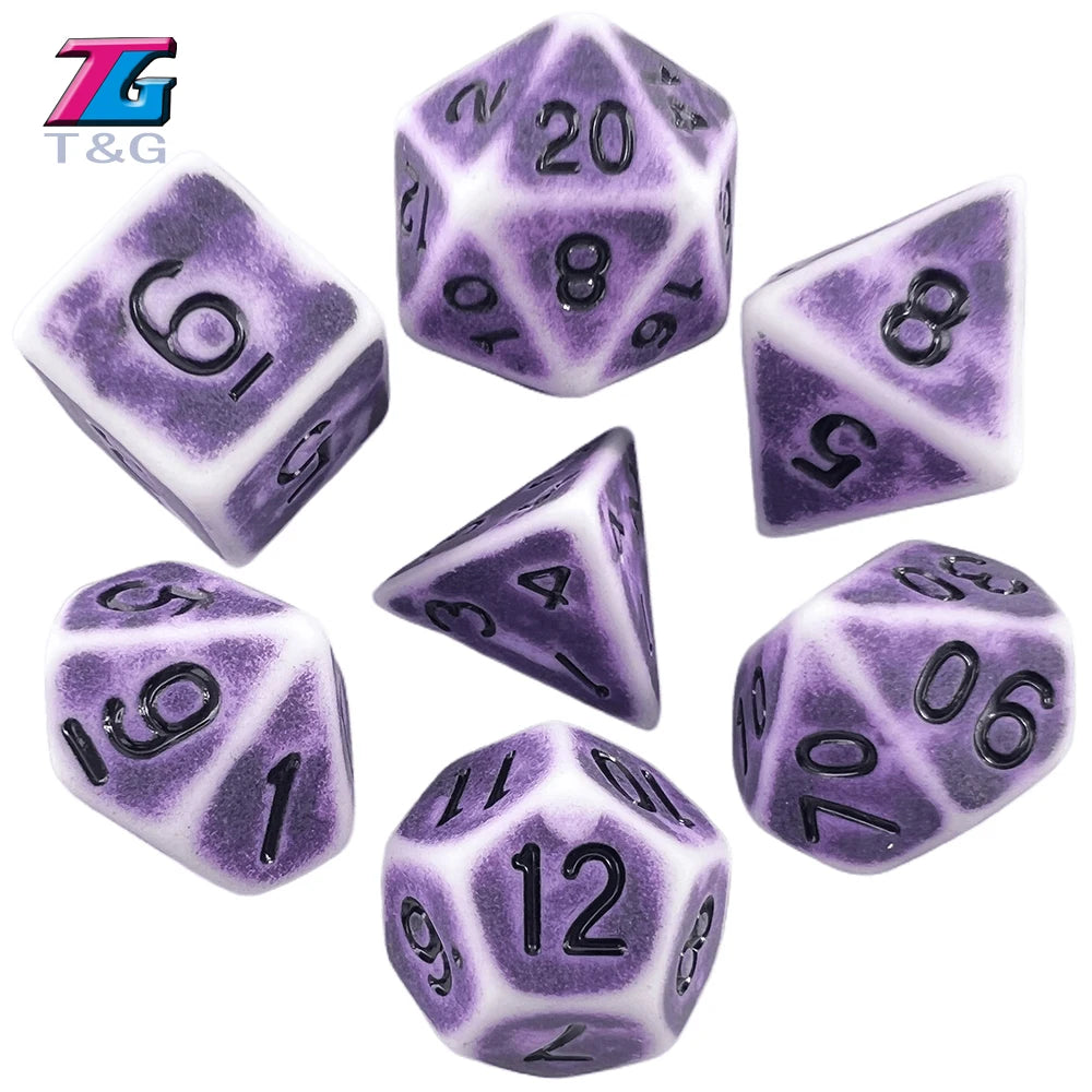 A set of purple and white polyhedral dice including a d20, d8, d10, d6, d12, and d10-sided dice.