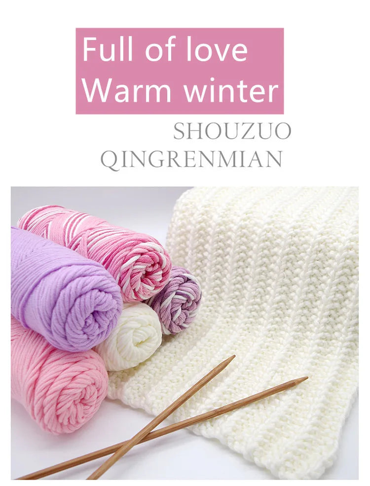 Spools of pink and purple yarn next to a cream knitted fabric, promoting a warm winter theme.