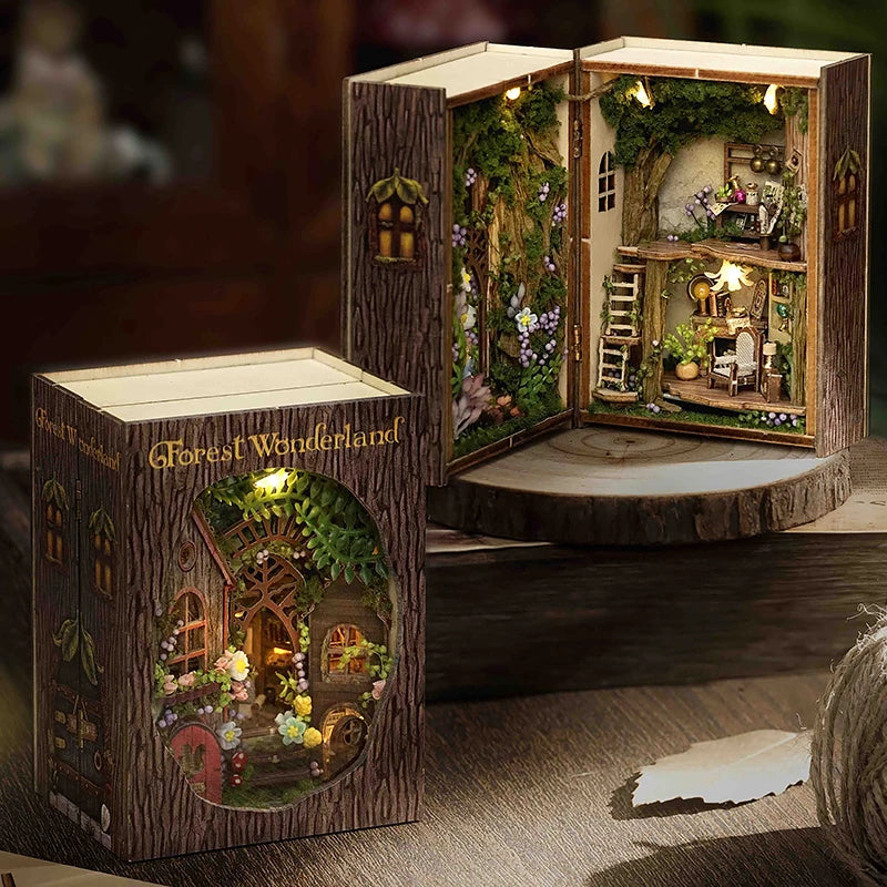 A wooden miniature dollhouse kit featuring a detailed forest wonderland scene with furniture and lighting.