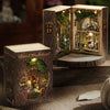 A wooden miniature dollhouse kit featuring a detailed forest wonderland scene with furniture and lighting.