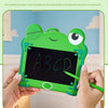 A child's hand holds a green frog-shaped LCD drawing tablet with the letters ABCD displayed on the screen.