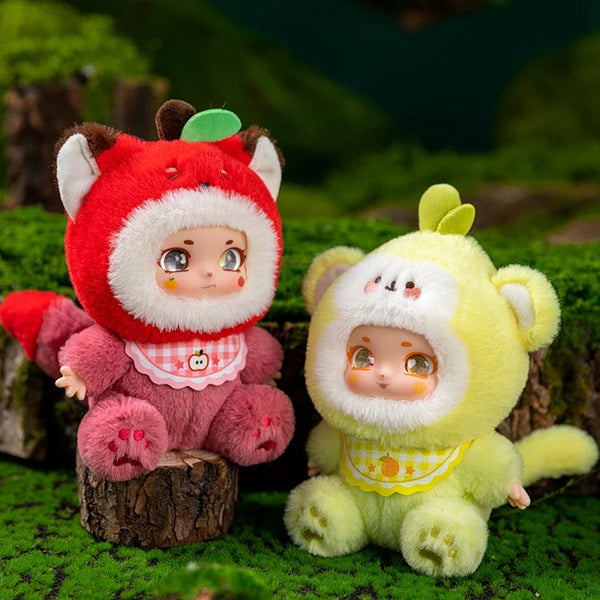 Two adorable plush keychains, one red and pink fox and one yellow bear, sitting on mossy wood.