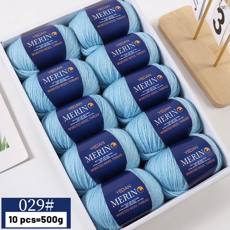 A box of YEDAN MERIN worsted wool thread yarn in blue and yellow colors for knitting projects