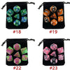 A set of 8 polyhedral dice in various colors stored in black fabric bags labeled #17 through #24.
