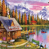 A wooden fishing tackle house sits by a lake surrounded by evergreen trees and mountains.