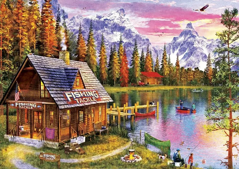 A wooden fishing tackle house sits by a lake surrounded by evergreen trees and mountains.
