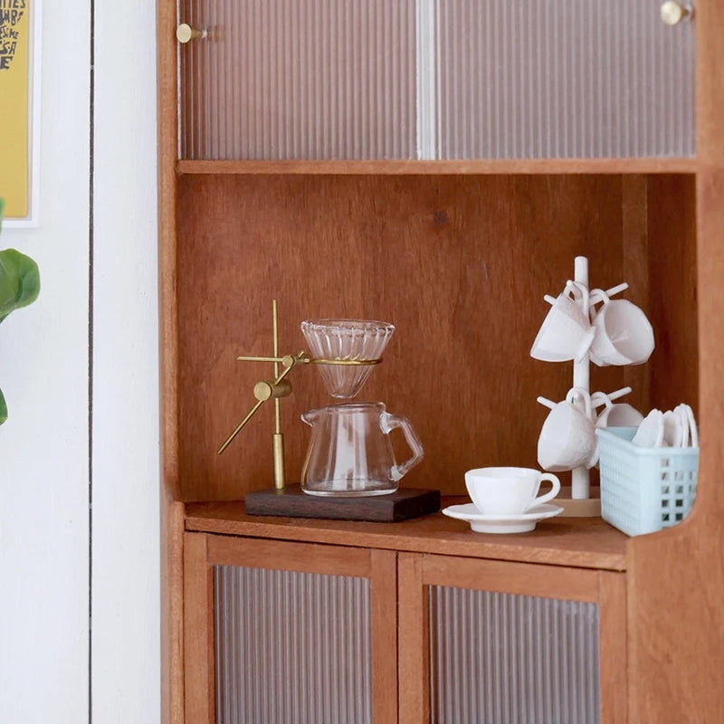 A wooden shelf display featuring a miniature hand-brewed coffee stand set for dollhouse, including a glass teapot and cups.