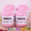 Four skeins of pink cotton knitting yarn labeled Golden Sun for crochet and handmade projects