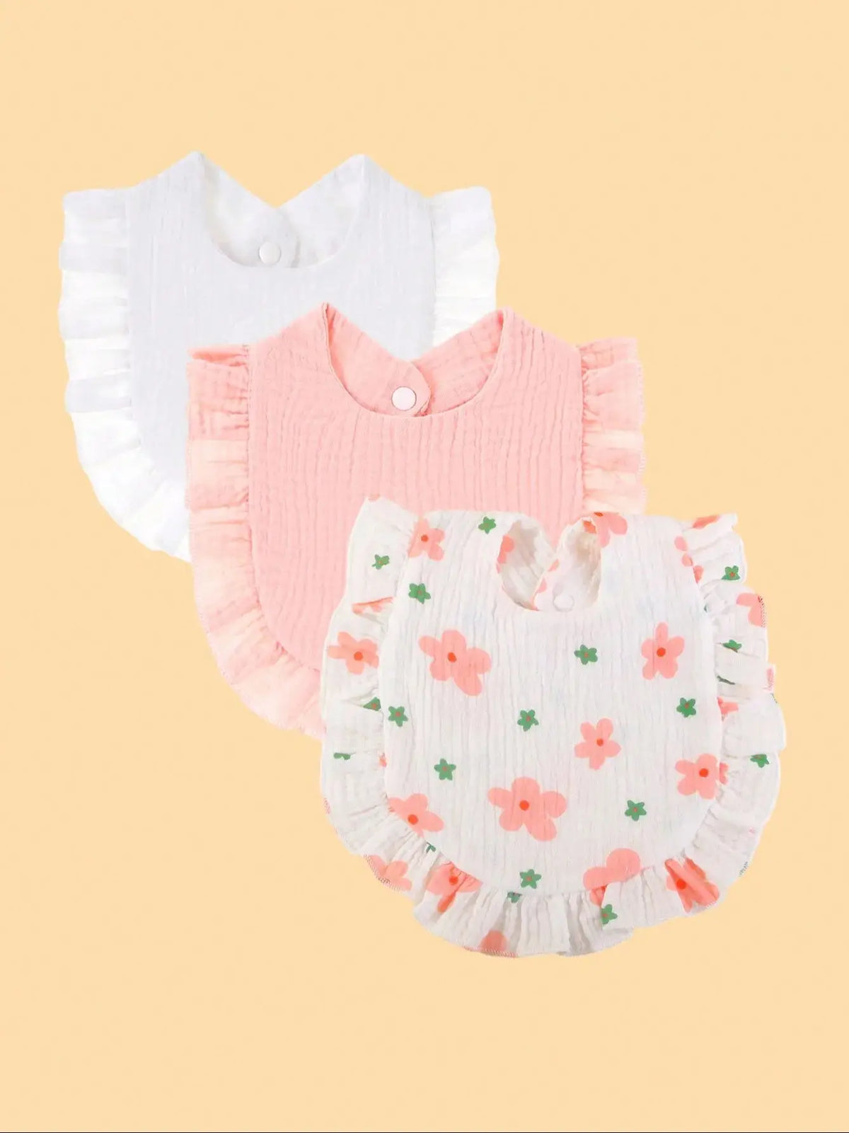 A set of three pure cotton muslin baby bibs in white, pink, and white with floral embroidery.