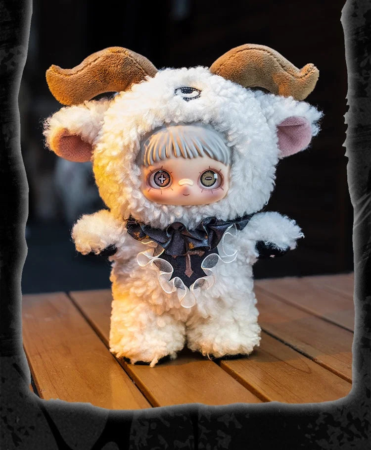 A fluffy white plush doll with brown horns and a dark ribbon detail sitting on a wooden surface.