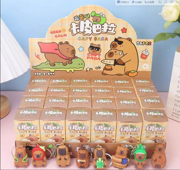 A display of cute capybara blind box key chain charms in various packaging and arrangements.
