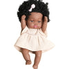 A dark-skinned baby doll with curly hair wearing a cream-colored, textured outfit and a pink bow.