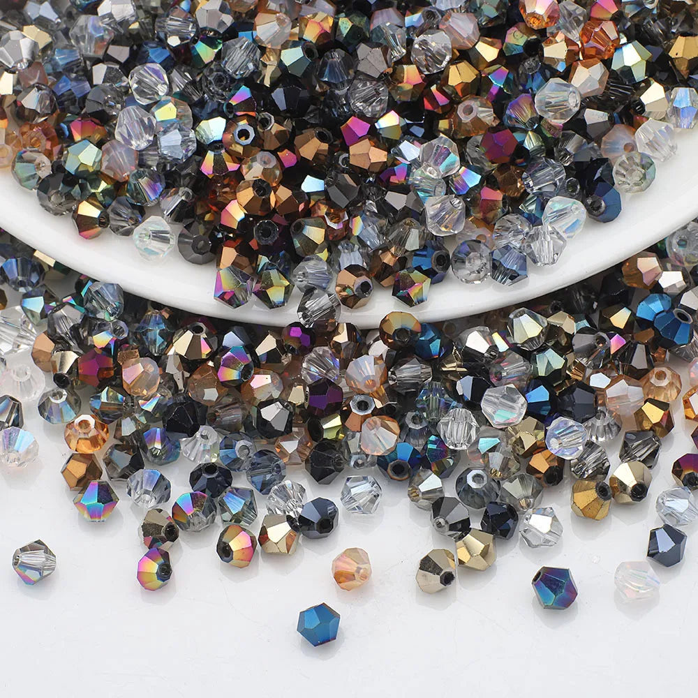 A pile of multicolor faceted glass crystal beads in various sizes and shapes for jewelry making