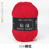 A ball of bright red milk cotton yarn labeled 35# silk thread for knitting and crochet.