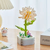 A set of rose flower building blocks in shades of yellow and green displayed on a wooden table.