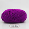 A ball of vibrant purple pre-dyed milk cotton yarn used for knitting and crochet.