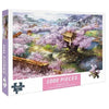 A box of a 1000-piece jigsaw puzzle featuring a scenic landscape with pink blossoms and a wooden structure.