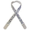 A beige woven guitar strap with blue floral patterns and leather accents, shown diagonally.