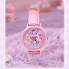 A pink watch featuring a pony design and glitter accents, displayed on a purple fuzzy surface.