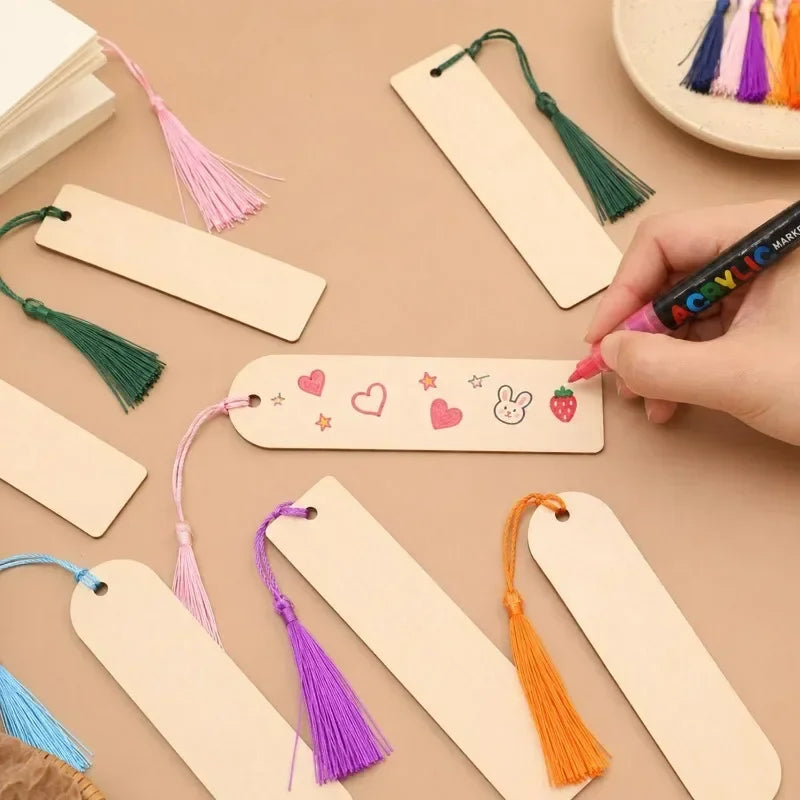 Various blank wooden bookmarks with colorful tassels are displayed on a neutral background.
