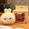 A yellow plush rabbit pendant with large blue eyes is displayed next to its packaging box.