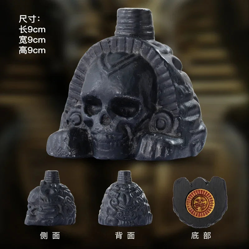 A handcrafted black Aztec death whistle shown from the front, back, and top views.