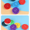 A collection of colorful math fidget spinners featuring various numbers and operations like plus and minus signs.