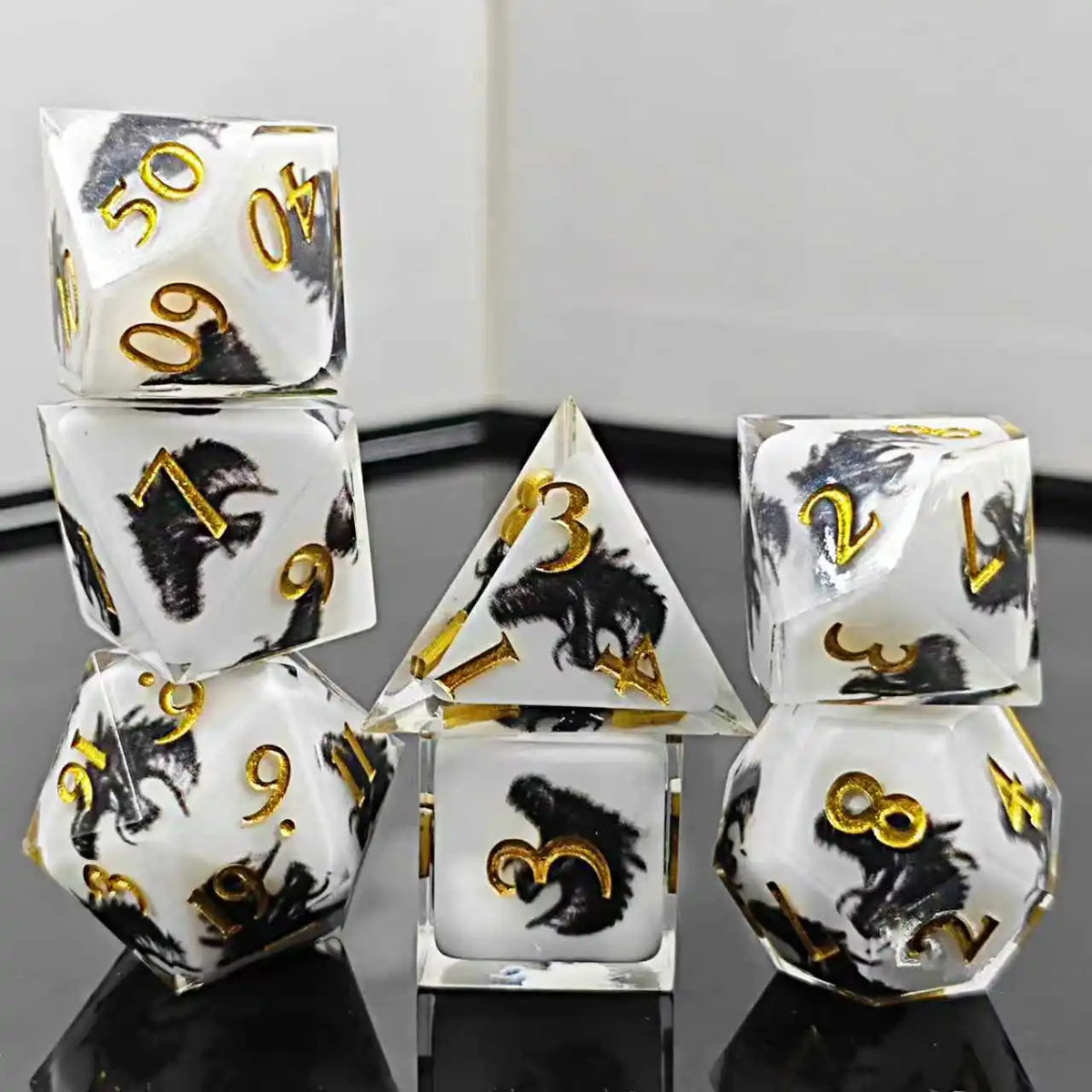 A set of milk white resin dice featuring a black kitten design, arranged on a reflective surface.