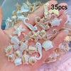 A hand holds a collection of pearl and gold-colored acrylic ocean animal beads for DIY jewelry making