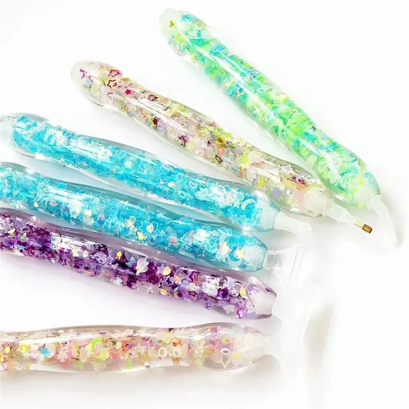 A collection of glow-in-the-dark diamond painting pens with various colorful tips displayed on a white background.