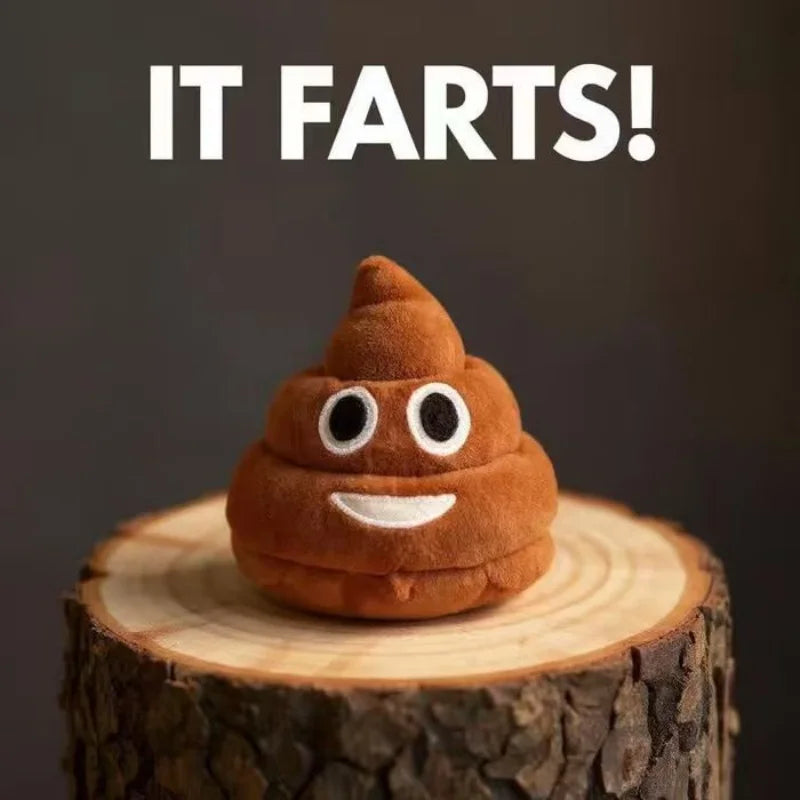 A brown plush toy shaped like a poop with white eyes and a smiling mouth sitting on a wooden log.