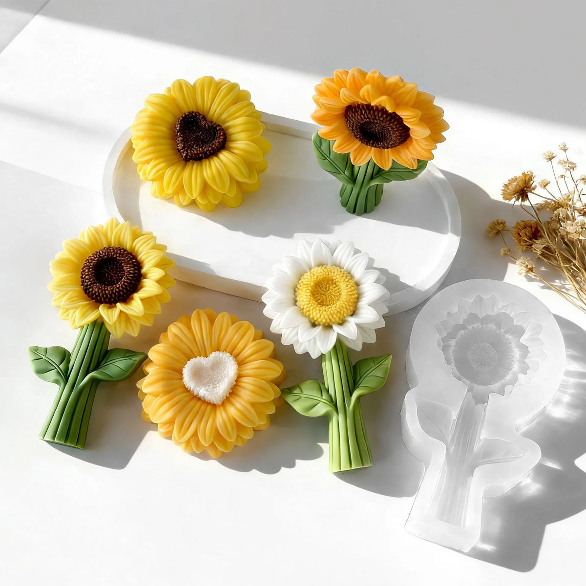 A collection of reusable silicone sunflower molds in yellow and white for candle making, resin, and soap.
