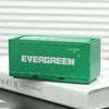 A green industrial storage box labeled EVERGREEN resting on a white book.