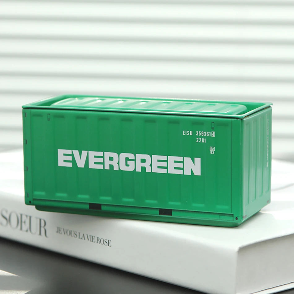 A green industrial storage box labeled EVERGREEN resting on a white book.