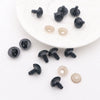 A collection of black and translucent plastic safety eyes with locking washers for amigurumi projects.
