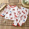 White long sleeve cotton pajama set for kids featuring a pattern of rabbits and strawberries.