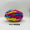 A ball of brightly colored chunky chenille yarn featuring purple, yellow, and blue stripes.