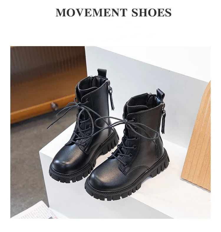 A pair of black Movement shoes, ankle boots with laces and a rubber sole, displayed on a white surface.