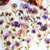 A collection of 50 transparent floral stickers featuring various purple and pink flowers on a white background.