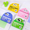 A collection of yellow and pink sticky notes with cute designs, including a pull-through dispenser.