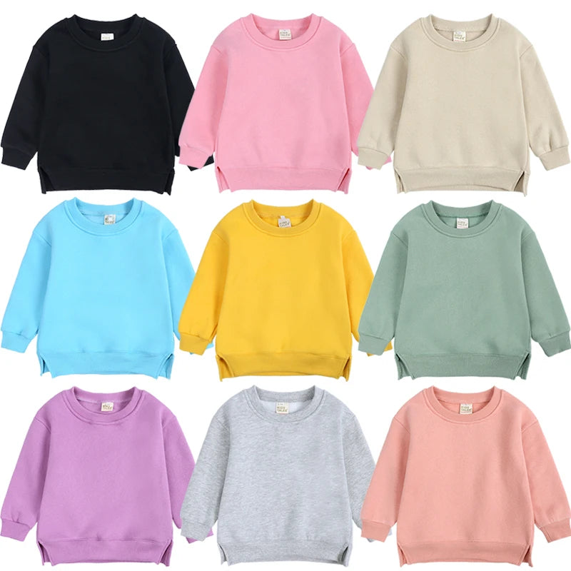 A collection of pastel colored pullover hoodies in pink, yellow, mint green, and lavender for kids.