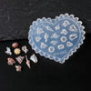 A heart-shaped silicone mold featuring intricate sea shell, starfish, and ocean designs for nail art.