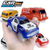 A hand holds a collection of LED glowing race cars, including a blue police car and orange jeep.
