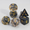 A set of polyhedral dice including a D4, D6, D8, D10, D12, and D20 made of dark, glittery resin.