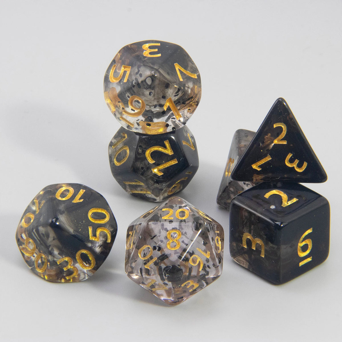 A set of polyhedral dice including a D4, D6, D8, D10, D12, and D20 made of dark, glittery resin.