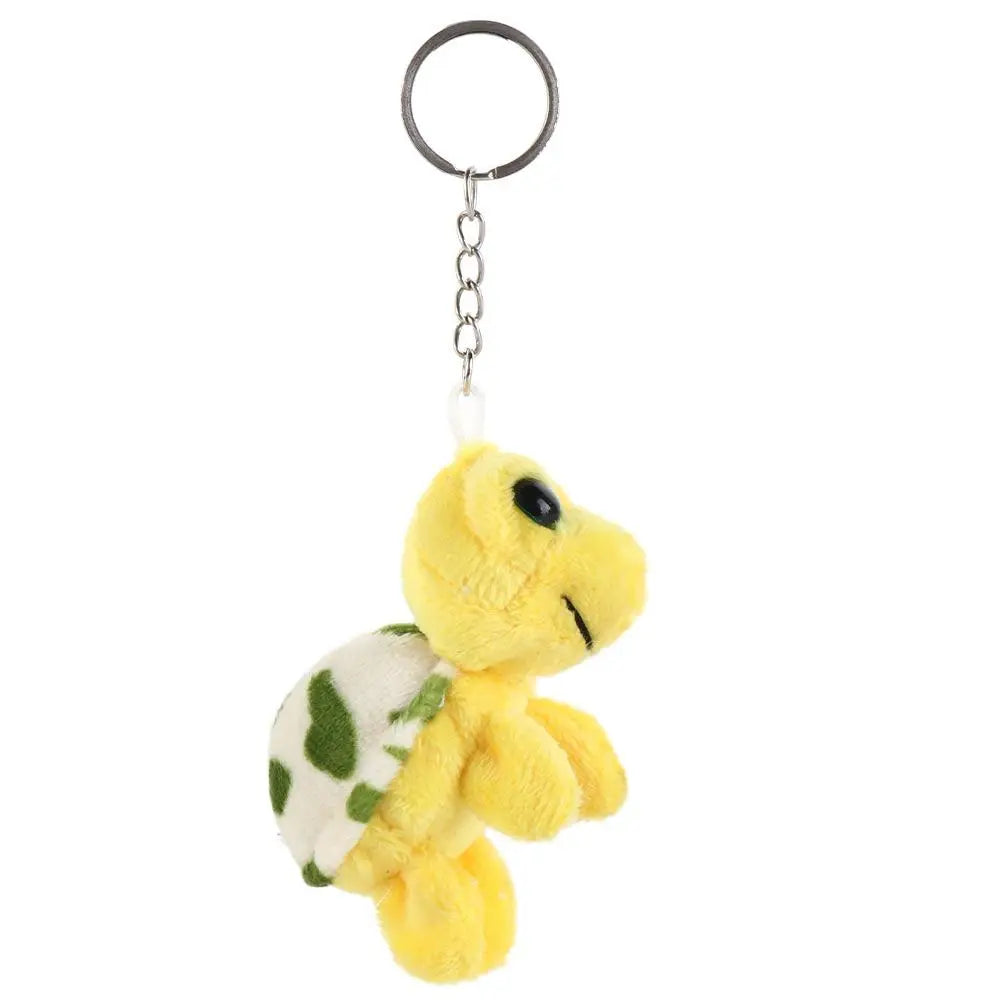 Yellow turtle plush keyring charm with a silver loop and green patterned body