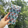 A hand holds a fabric storage bag featuring a pattern of white Miffy rabbits on a teal background.
